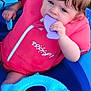 toddler, child, life_jacket, inflatable_pool, toy, purple_toy, blue_pool, pink_clothing, summer, outdoor, grass, water_toys, cute, chewing, playtime, baby, infant, fun, safety, colorful