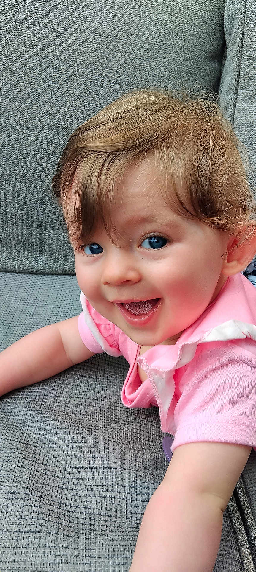 Ella-May joined the competition — help win amazing prizes! toddler, child, smiling, pink_clothing, couch, indoor, happy, baby, face, portrait, cute, young_child, skin, hair, blue_eyes, infant, person, arm, texture, fabric