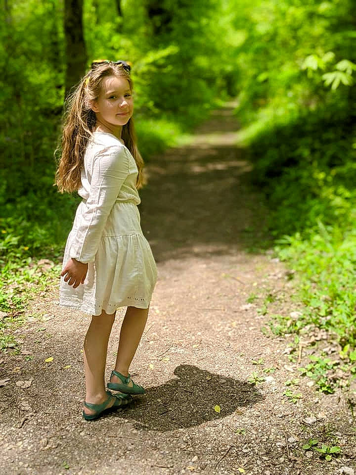 Adalee is registered to the contest to win money with this photo: day_dress, fawn, flash_photography, forest, grass, happy, human_leg, knee, long_hair, one_piece_garment, people_in_nature, person, plant, sandal, shoe, street_fashion, sunlight, thigh, tree, waist