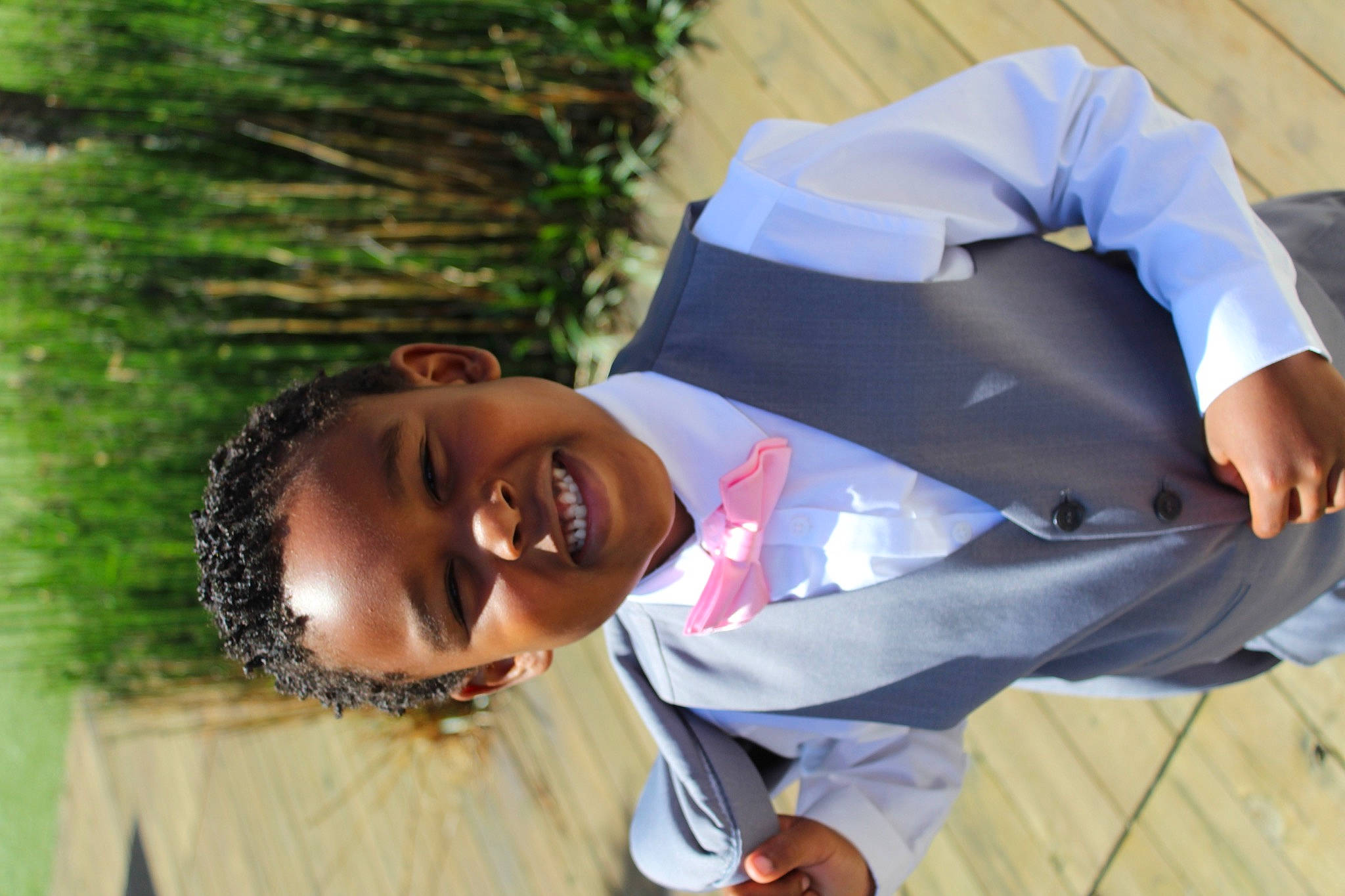 Benjamin J Landry is registered to the contest to win money with this photo: child, event, formal_wear, fun, gesture, grass, happy, jewellery, joy, laugh, leisure, necklace, people_in_nature, person, plant, portrait_photography, recreation, sitting, sleeve, smile