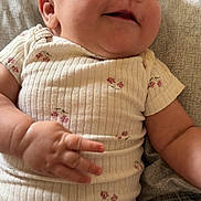 Ariana joined the competition — help win amazing prizes! baby, infant, smiling, onesie, floral_pattern, chubby_cheeks, hand, face, skin, cute, happy, lying_down, soft_texture, clothing, casual, child, person, indoors, comfort, portrait