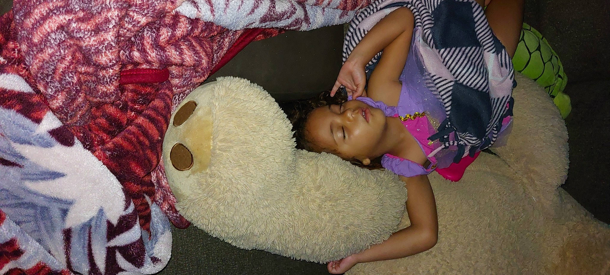 Lyric is registered to the contest to win money with this photo: abdomen, child, comfort, fashion_accessory, fun, fur, happy, human_leg, linens, magenta, pattern, person, plush, room, stuffed_toy, teddy_bear, textile, thigh, toy