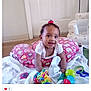 Layla joined the competition — help win amazing prizes! baby, child, smiling, indoor, pillow, toys, blanket, floor, hair_tie, white_door, armchair, colorful, happy, infant, crawling, playtime, person, young_child, cute, soft_toys