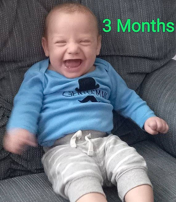 Jayjay is registered to the contest to win money with this photo: baby, baby_toddler_clothing, cheek, child, comfort, cool, couch, flash_photography, grey, hairstyle, happy, iris, mouth, person, product, sitting, skin, sleeve, smile, t_shirt