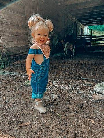 Gentry joined the competition — help win amazing prizes! baby, baby_toddler_clothing, child, electric_blue, fun, grass, happy, human_leg, joy, landscape, leisure, livestock, people_in_nature, person, play, recreation, sandal, sitting, smile, soil