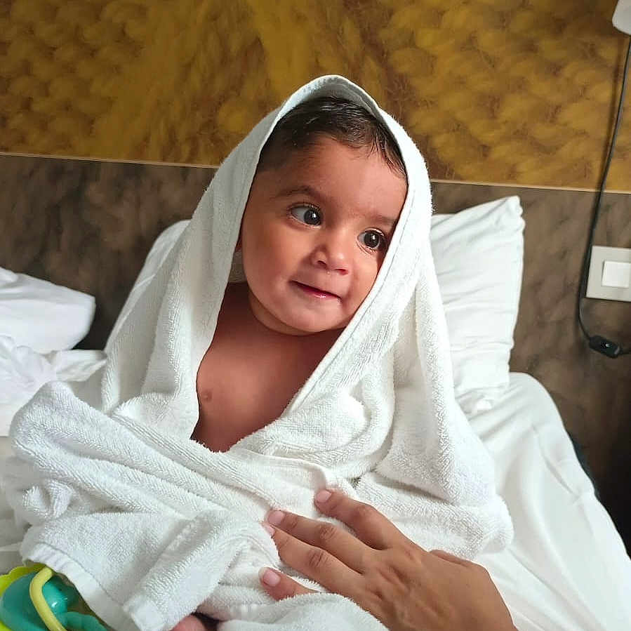 Arsal is registered to the contest to win money with this photo: baby, bed, bedroom, care, child, comfort, cute, hand, indoor, infant, person, portrait, skin, smile, soft, texture, towel, warm, white_towel, wrapped