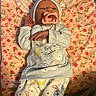 adult_hands, baby, bed, blanket, clothing, cozy, cute, floral_blanket, hat, indoor, infant, newborn, nursery, onesie, pacifier, pajamas, portrait, sleeping, space_theme, stuffed_character
