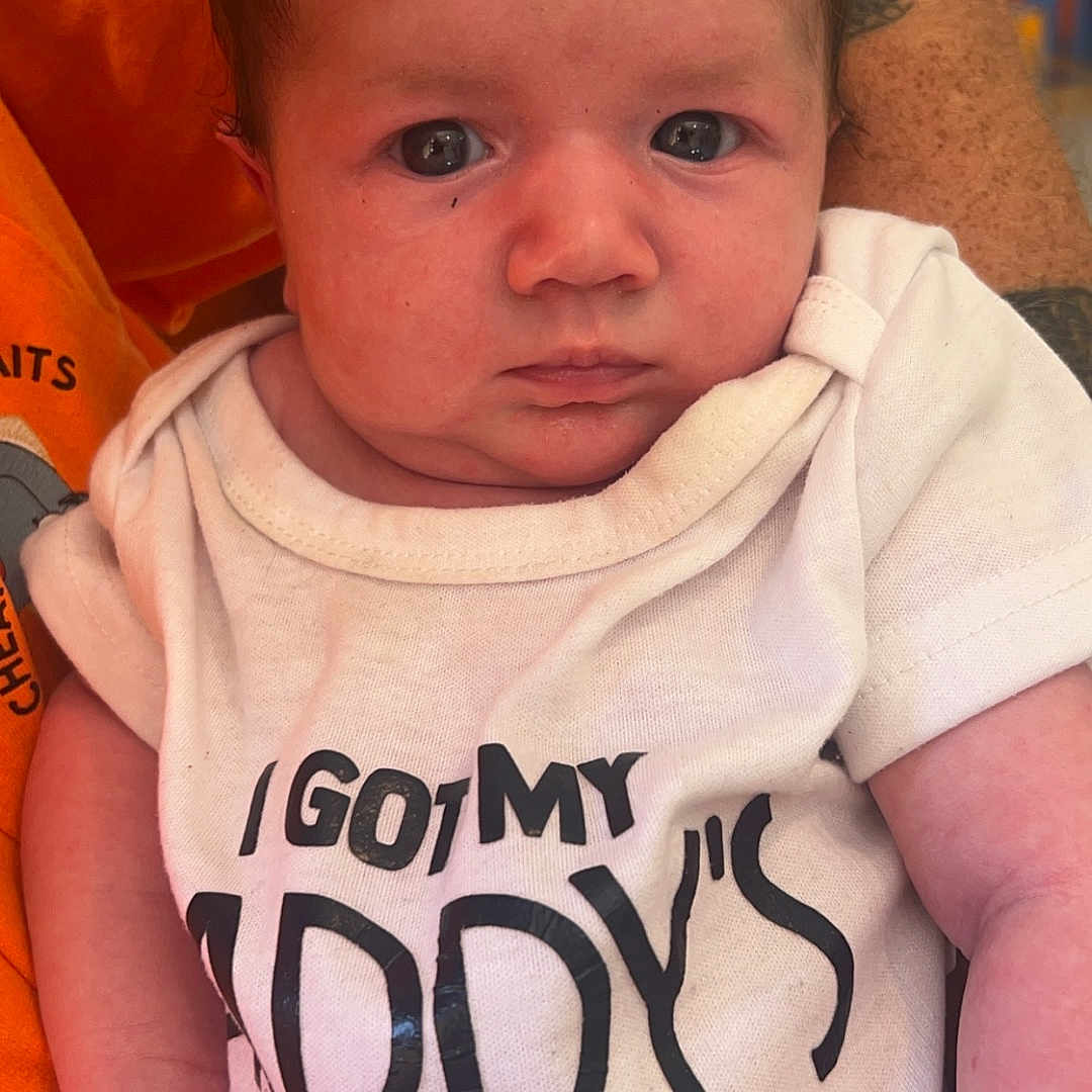 Emma is registered to the contest to win money with this photo: baby, blanket, bodypart, clothing, couch, cushion, face, finger, frown, furniture, hand, head, homedecor, newborn, person, photography, portrait, sad, sleeping, t_shirt