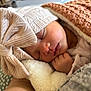 baby, sleeping, blanket, hat, bow, cozy, child, face, hand, soft, warm, cute, newborn, apparel, indoors, portrait, rest, peaceful, infant, closeup