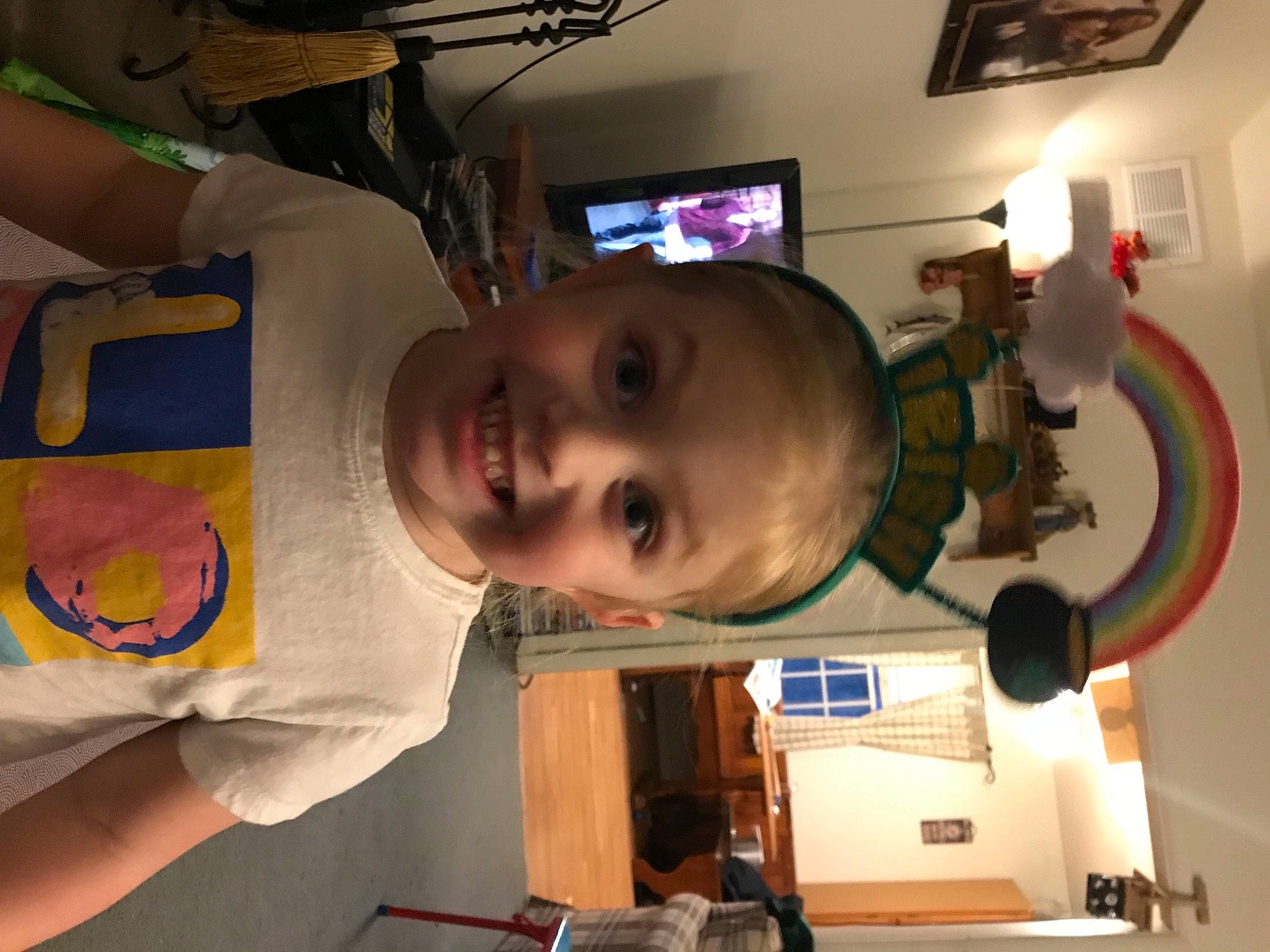 Cheyenne is registered to the contest to win money with this photo: art, baby, ceiling, child, ear, fun, houseplant, joy, machine, person, picture_frame, room, smile, space, t_shirt, television, toddler