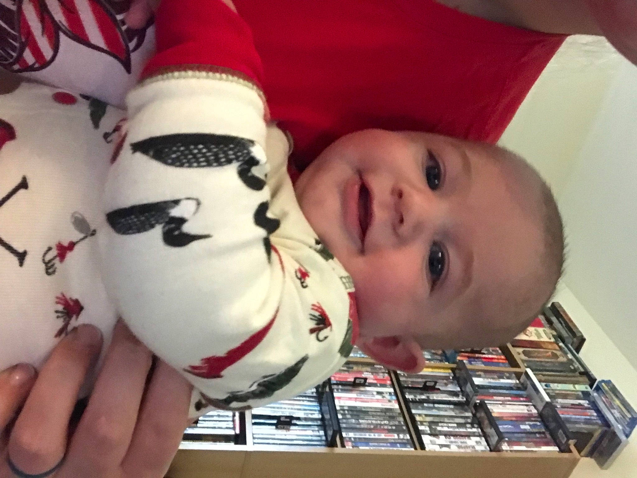 Edgar is registered to the contest to win money with this photo: baby, carmine, child, facial_expression, finger, flooring, foot, fun, glove, hand, happy, human_leg, leg, nail, person, shelf, smile, thigh, thumb, toddler