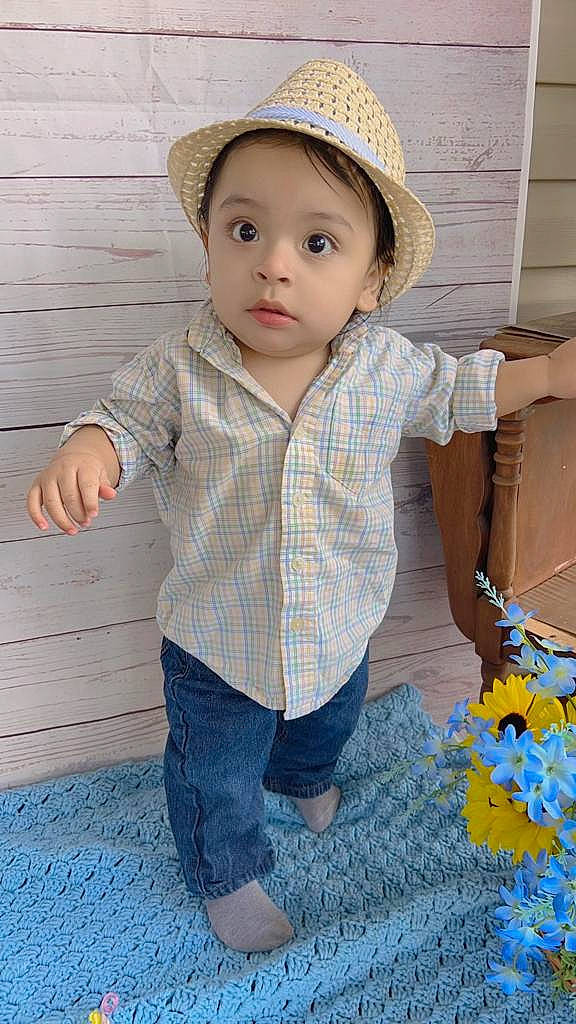 Christian is registered to the contest to win money with this photo: baby_toddler_clothing, blue, cheek, chin, clothing, dress_shirt, eye, face, happy, hat, headwear, human_body, iris, jeans, lip, nose, person, product, skin, sleeve