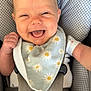 Leighton joined the competition — help win amazing prizes! baby, smiling, happy, infant, car_seat, seatbelt, bib, clothing, daisy_pattern, cute, child, person, portrait, head, face, skin, happy_expression, sitting, indoor, closeup