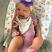Leighton joined the competition — help win amazing prizes! baby, infant, smile, purple_onesie, headband, floral_pattern, baby_seat, toy, happy, cute, child, skin, foot, hand, fabric, comfort, indoors, portrait, bandana, accessory
