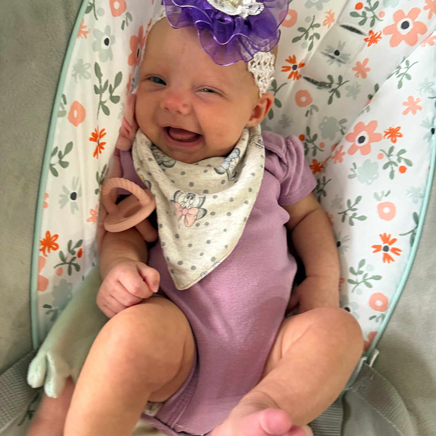 Leighton joined the competition — help win amazing prizes! accessory, baby, baby_seat, bandana, child, comfort, cute, fabric, floral_pattern, foot, hand, happy, headband, indoors, infant, portrait, purple_onesie, skin, smile, toy