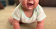 Isabella is registered to the contest to win money with this photo: baby, carpet, child, clothing, crawling, cute, expression, eyes, face, hands, happy, home, indoor, infant, living_room, person, portrait, short_sleeves, skin, smiling