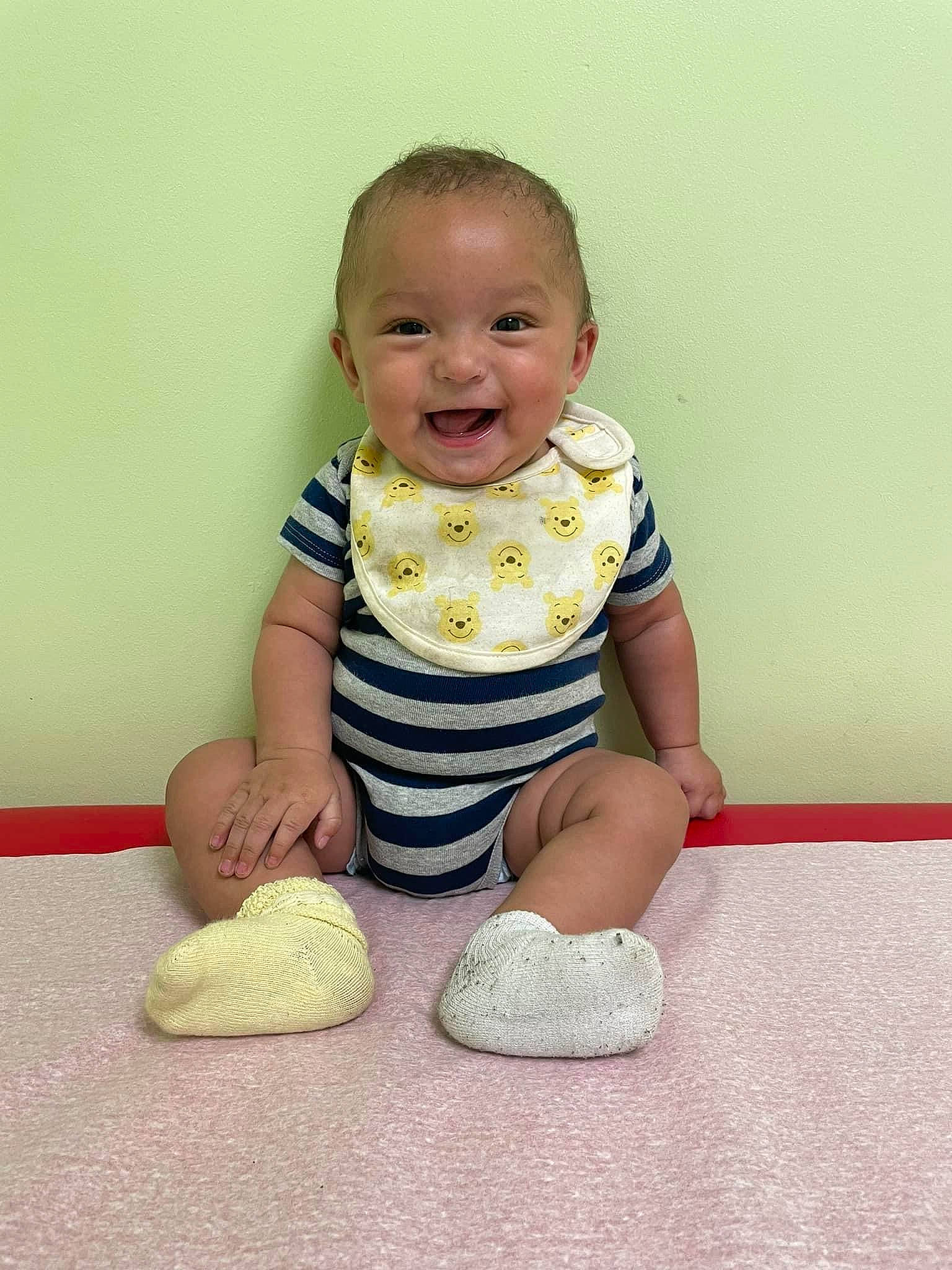Miguel is registered to the contest to win money with this photo: baby, baby_toddler_clothing, barefoot, cheek, child, comfort, flooring, foot, fun, happy, human_leg, joy, knee, pattern, person, portrait_photography, sitting, sleeve, smile, sock