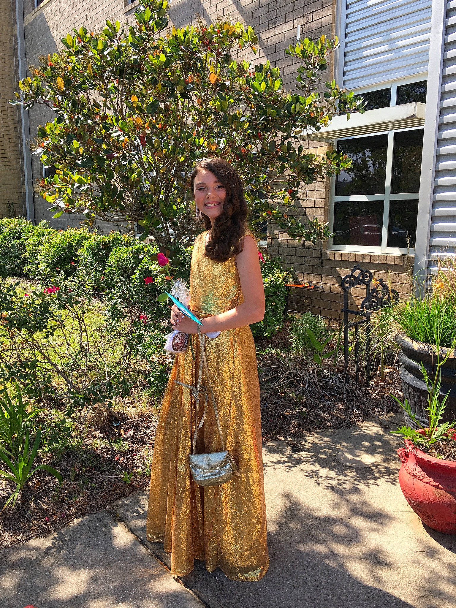 Monroe is registered to the contest to win money with this photo: building, day_dress, event, fashion_design, fawn, flooring, flowerpot, formal_wear, gown, grass, houseplant, joy, landscape, lawn, one_piece_garment, person, plant, shrub, street_fashion, trunk