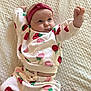Kaya is registered to the contest to win money with this photo: baby, infant, child, pajamas, strawberry_pattern, headband, blanket, texture, cute, portrait, lying_down, clothing, sleepwear, hand_raised, expression, indoor, soft_lighting, person, young_child, adorable
