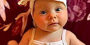 Kaya joined the competition — help win amazing prizes! baby, infant, headband, white_clothing, portrait, face, eyes, skin, cute, child, person, indoors, soft_light, background, floral_pattern, tank_top, fashion, headwear, closeup, adorable