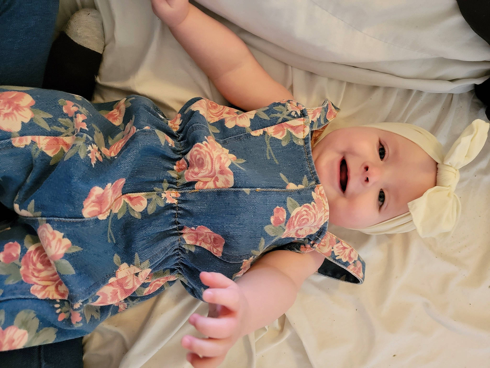 Dekklynn is registered to the contest to win money with this photo: baby, baby_toddler_clothing, comfort, dress, eye, eyelash, finger, gesture, hand, happy, human_body, joy, nail, pattern, person, pink, plant, skin, sleeve, textile