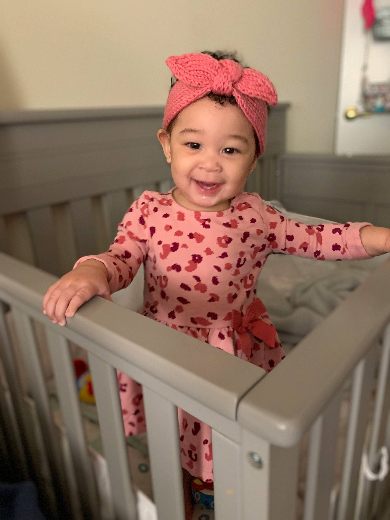 Alivia joined the competition — help win amazing prizes! baby, baby_safety, baby_toddler_clothing, cap, cradle, fun, happy, human_body, joy, magenta, nursery, outerwear, pattern, person, picture_frame, pink, sleeve, smile, standing, t_shirt