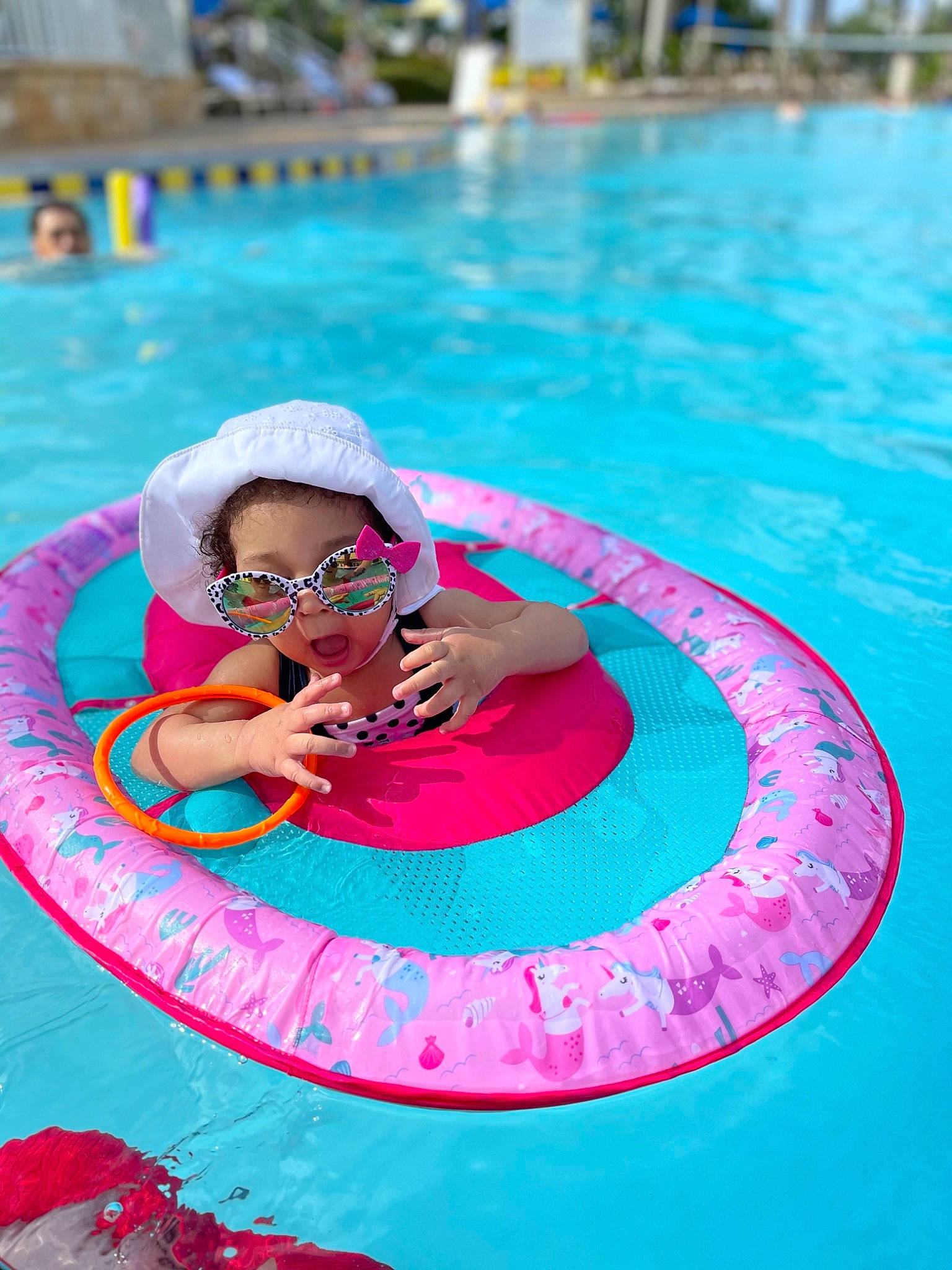 Alivia is registered to the contest to win money with this photo: aqua, blurred, circle, electric_blue, eyewear, fun, goggles, happy, leisure, magenta, outdoor_recreation, person, personal_protective_equipment, pink, recreation, summer, sunglasses, swimming_pool, travel, vacation