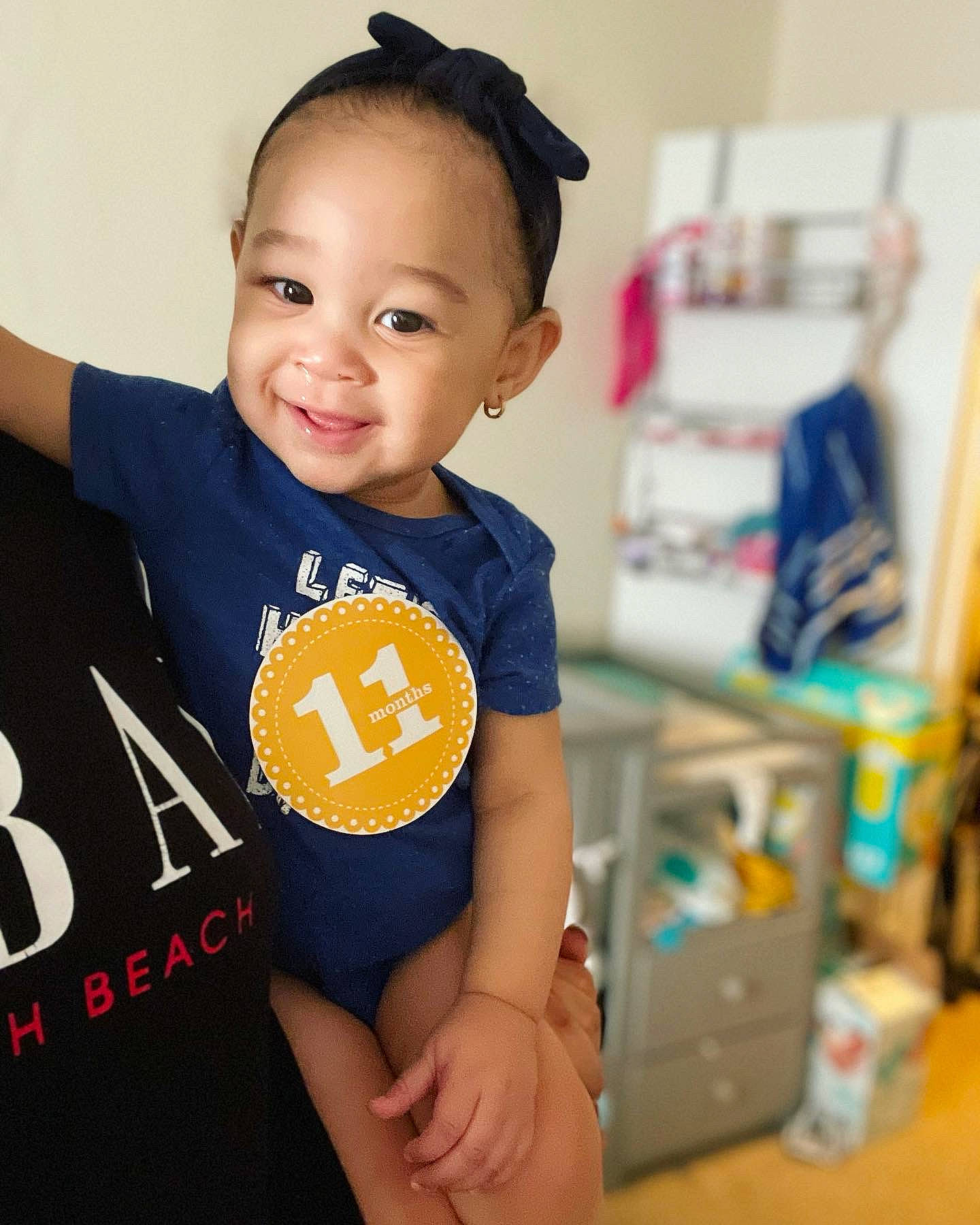 Alivia is registered to the contest to win money with this photo: baby, baby_toddler_clothing, child, elbow, electric_blue, hair, hairstyle, happy, joy, neck, person, shoulder, skin, sleeve, smile, sportswear, standing, t_shirt, thigh, toddler