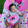 baby, infant, child, portrait, sitting, pink, minnie_mouse, baby_seat, car_seat, straps, wide_eyed, blue_eyes, curly_hair, white_shirt, colorful, polka_dots, hearts, stars, outdoor, grass