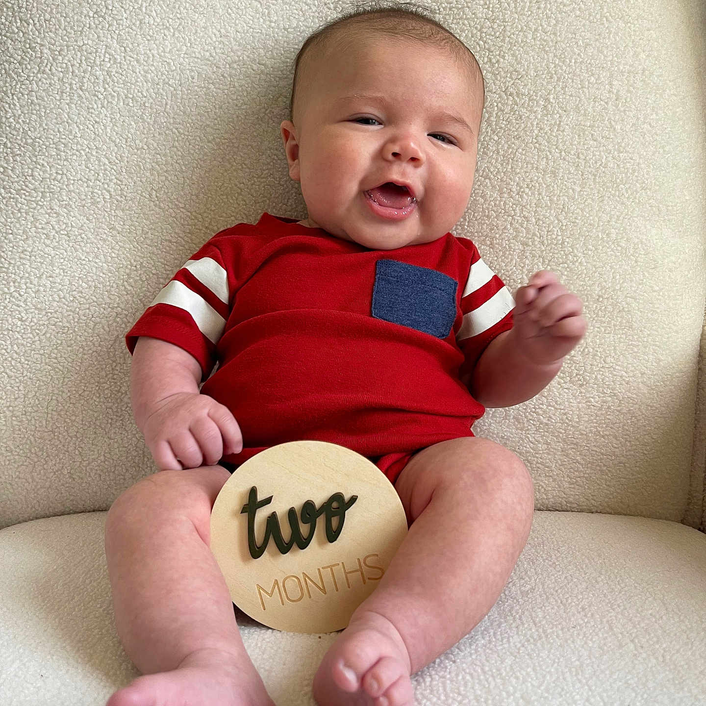 Archer is registered to the contest to win money with this photo: baby, ball, bodypart, clothing, cushion, face, finger, hand, happy, head, homedecor, newborn, person, photography, portrait, rugby, rugbyball, sitting, sport, t_shirt