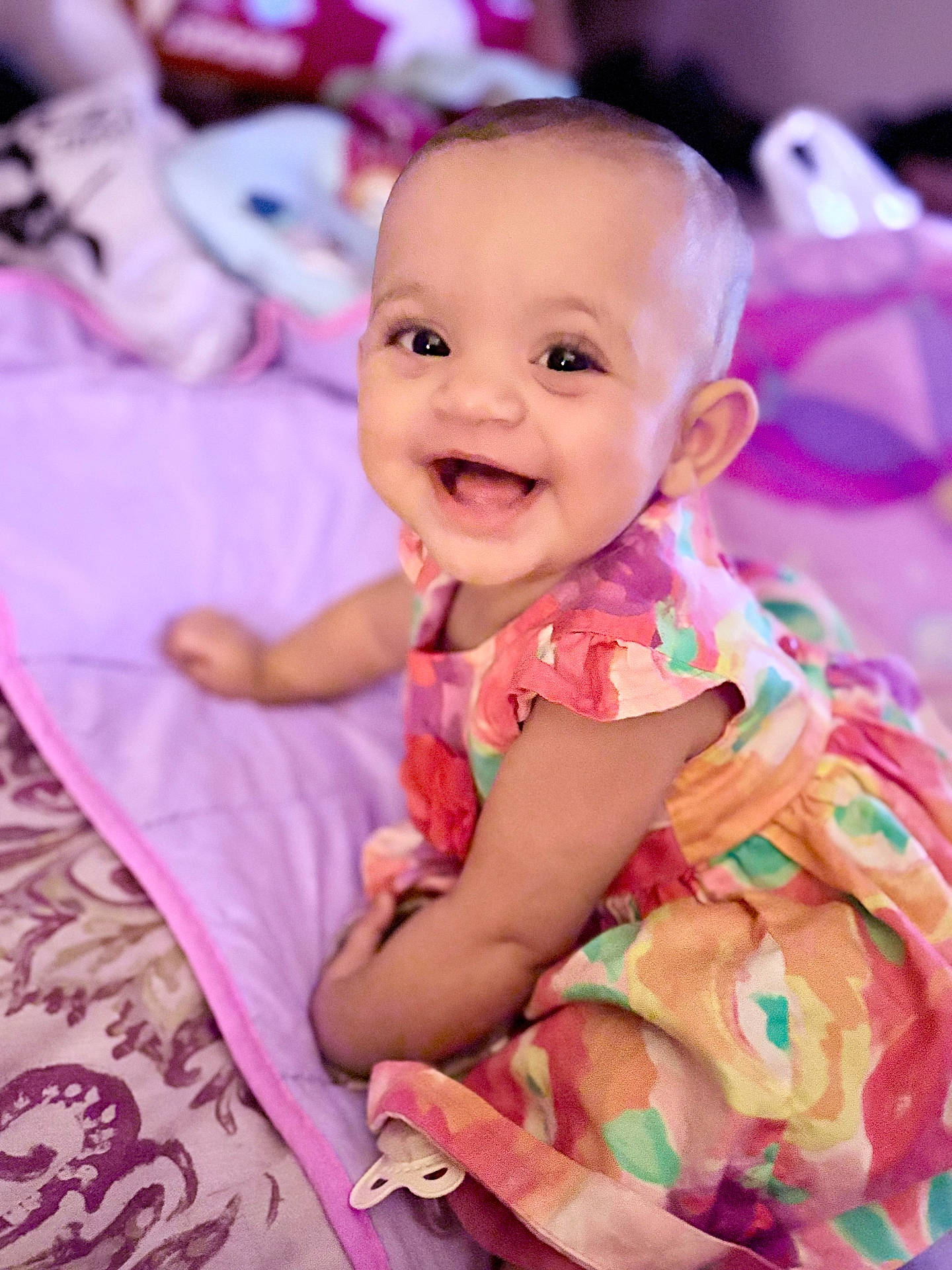 Ashley Saraev joined the competition — help win amazing prizes! baby, blanket, bright_eyes, candid, child, closeup, colorful_dress, cute, floral_pattern, happy, indoors, infant, joyful, person, portrait, sitting, skin, smiling, soft_lighting, young_child