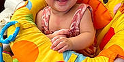 Ashley Saraev joined the competition — help win amazing prizes! baby, smiling, child, giraffe, baby_seat, toys, colorful, happy, infant, cute, playful, indoors, clothing, face, person, seat, plastic, fabric, expression, sitting