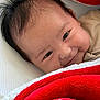 baby, smiling, face, blanket, red, white, closeup, infant, cute, happy, soft, texture, hair, eyes, resting, portrait, child, warm, cozy, indoors