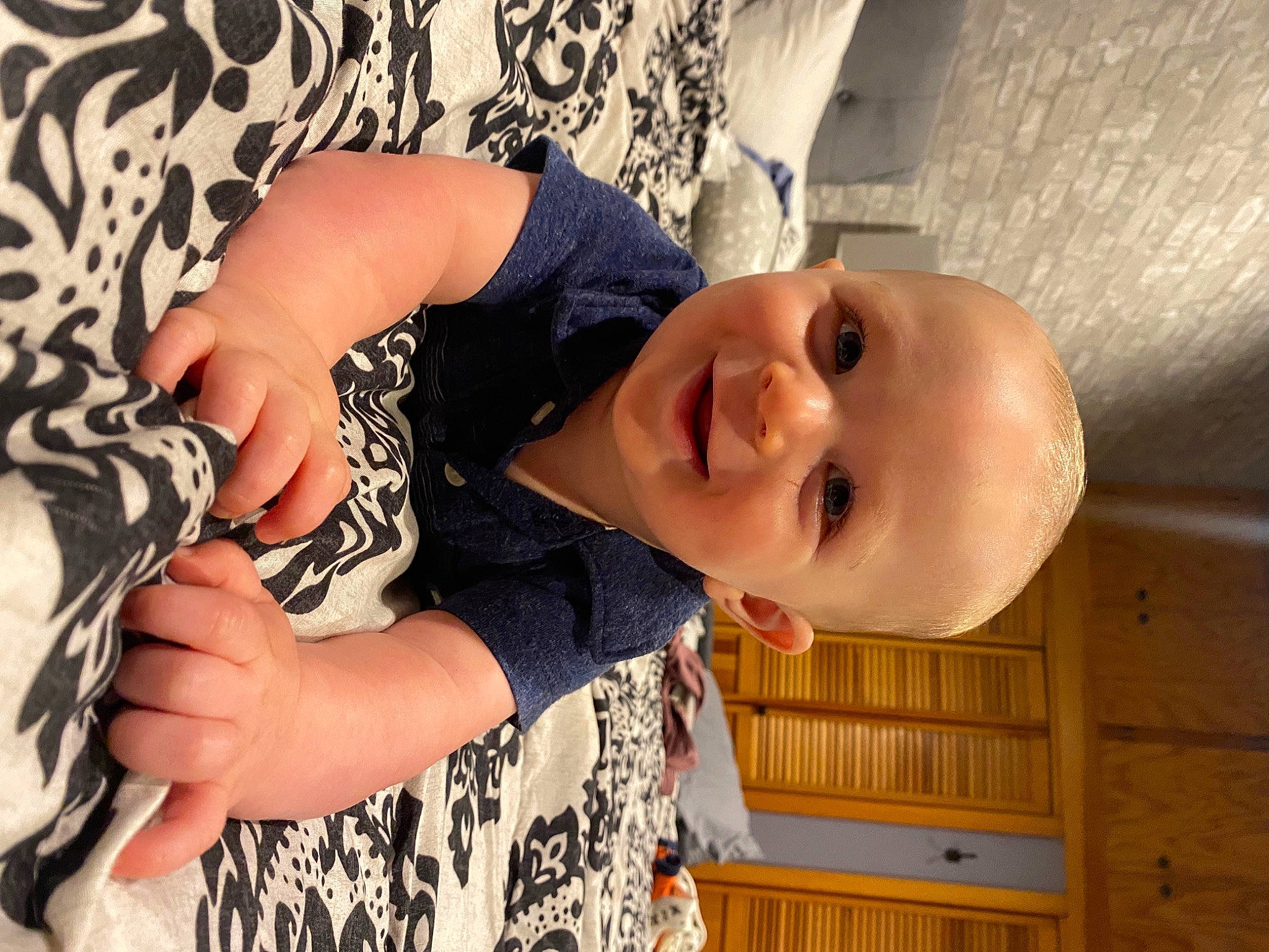 Luciano is registered to the contest to win money with this photo: baby, baby_toddler_clothing, cheek, child, elbow, eye, eyelash, finger, gesture, hand, happy, human_body, joy, neck, nose, pattern, person, skin, sleeve, smile