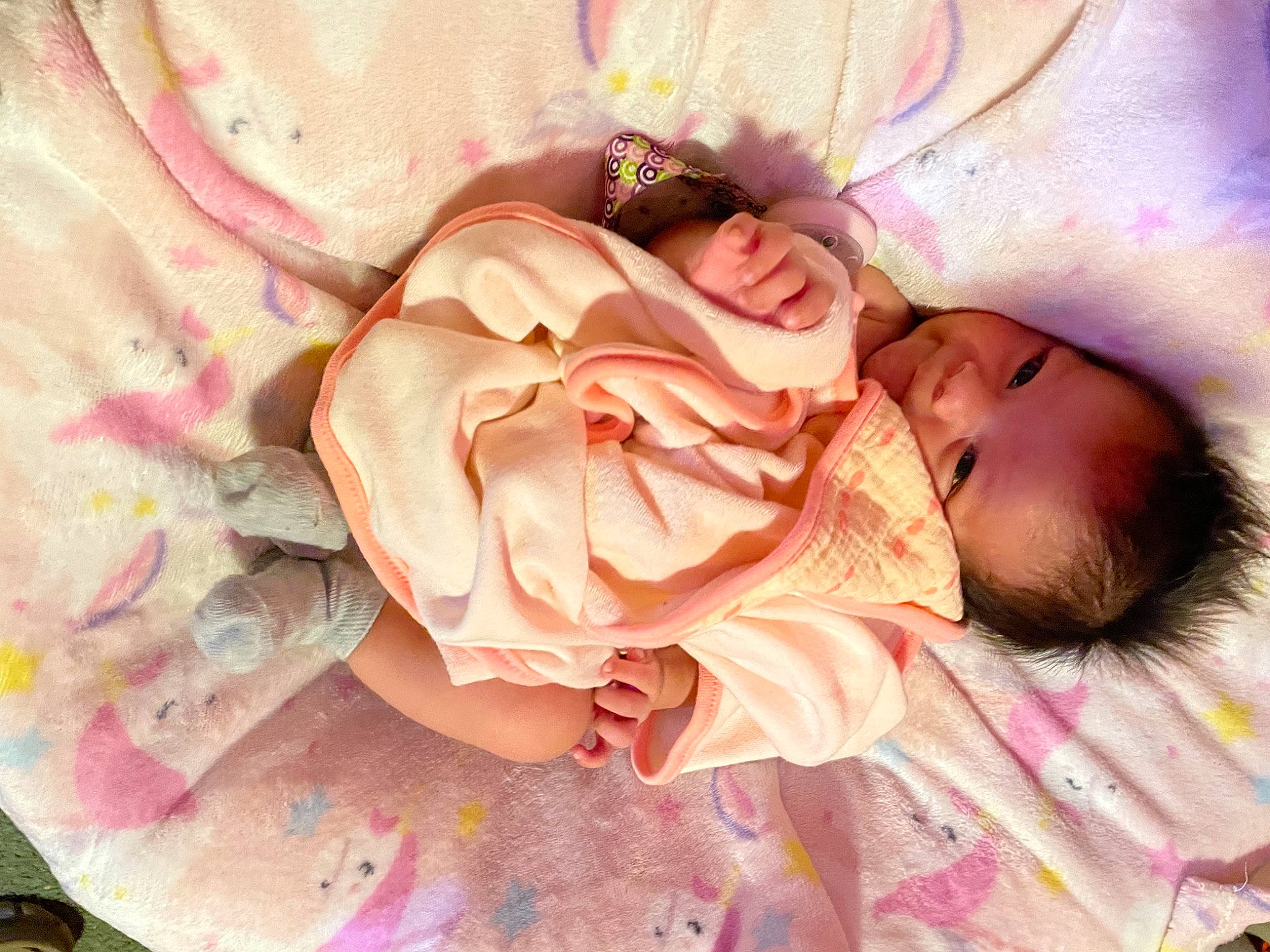 Lilianna is registered to the contest to win money with this photo: baby, baby_products, baby_toddler_clothing, cheek, child, comfort, fashion_accessory, hair_accessory, linens, pattern, peach, person, petal, pink, plant, rose, rose_family, rose_order, skin, sweetness