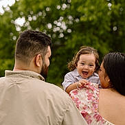 Octavian joined the competition — help win amazing prizes! back_view, beard, casual_clothing, child, curly_hair, family, floral_dress, greenery, happy, holding, love, man, nature, outdoor, parent, portrait, smiling, toddler, together, woman