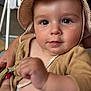 baby, infant, hat, striped_hat, beige_jacket, diaper, cute, close_up, indoor, person, child, face, skin, eyes, hand, clothing, cute_expression, baby_girl, baby_boy, adorable