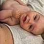 baby, smile, diaper, blanket, skin, face, infant, hand, arm, torso, tattoo, texture, closeup, lying, happy, person, child, cute, playful, resting