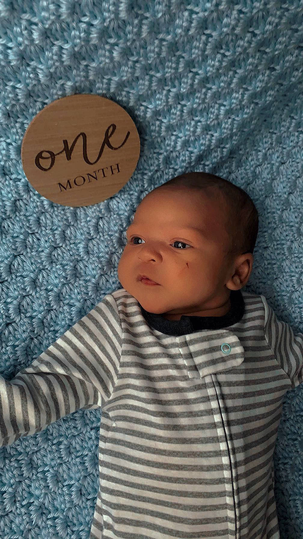 Dimitry is registered to the contest to win money with this photo: baby, baby_toddler_clothing, cheek, child, facial_expression, font, hairstyle, handwriting, happy, nose, pattern, person, portrait_photography, room, sitting, skin, sleeve, smile, t_shirt, toddler