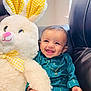 baby, bunny, chair, child, cuddly, cute, face, golden_necklace, hand, happy, indoor, infant, leather, plush_toy, portrait, smiling, stuffed_animal, teal_clothing, toy, yellow