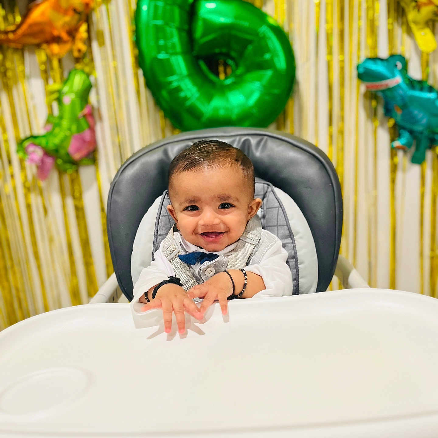 Shaurya joined the competition — help win amazing prizes! baby, balloon, birthday, celebration, child, clothing, cute, decorations, dinosaur_balloon, face, festive, food_tray, happy, high_chair, indoor, infant, number_six, party, seat, smiling