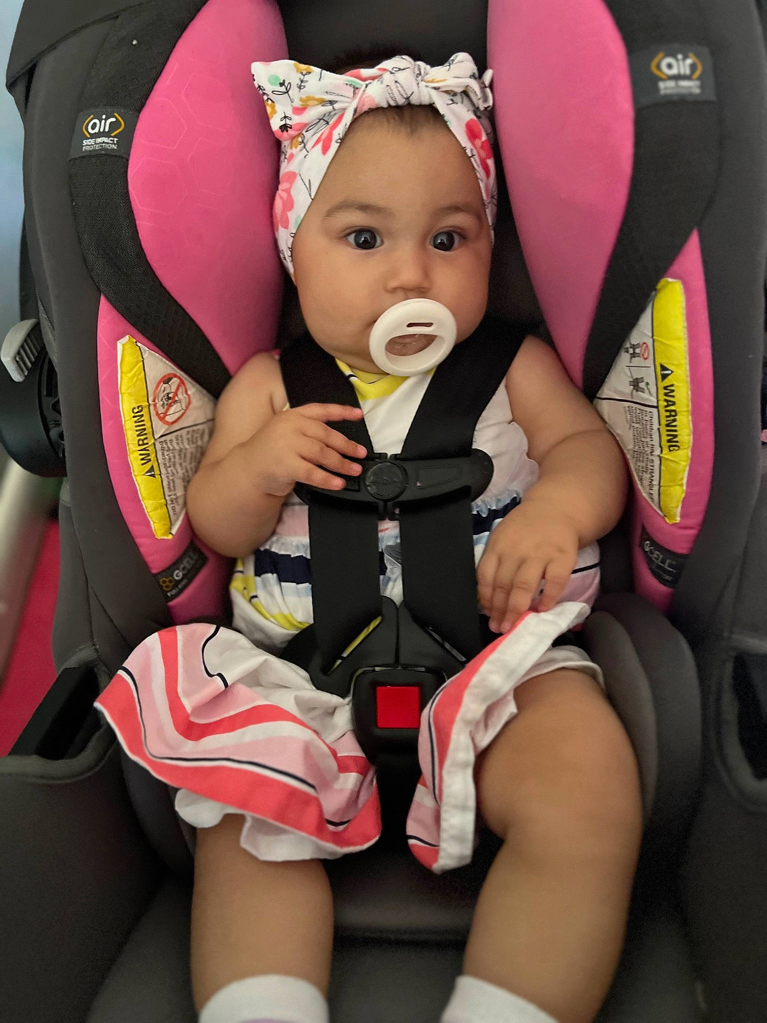 Rose is registered to the contest to win money with this photo: baby, baby_carriage, baby_products, baby_safety, baby_toddler_clothing, car_seat, chair, child, comfort, fashion_accessory, happy, lap, person, personal_protective_equipment, pink, seat_belt, sitting, sleeve, smile, thigh