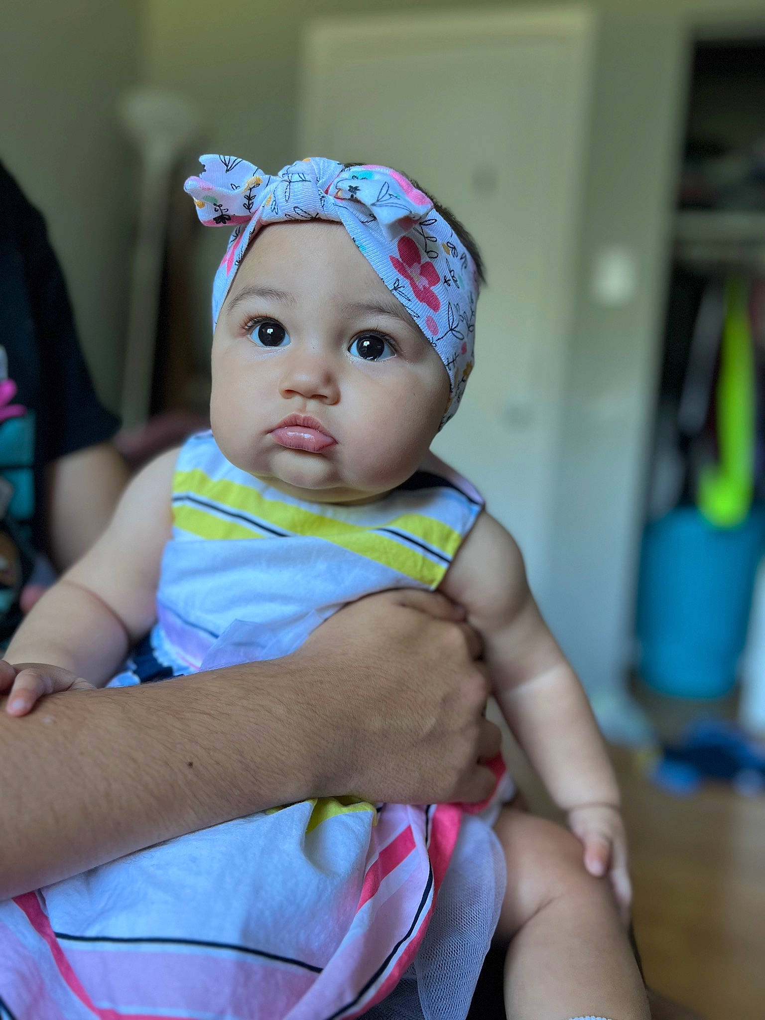 Rose is registered to the contest to win money with this photo: baby, baby_products, baby_toddler_clothing, beanie, cap, cheek, child, event, fashion_accessory, fun, happy, hat, headband, headpiece, headwear, person, room, sitting, skin, toddler