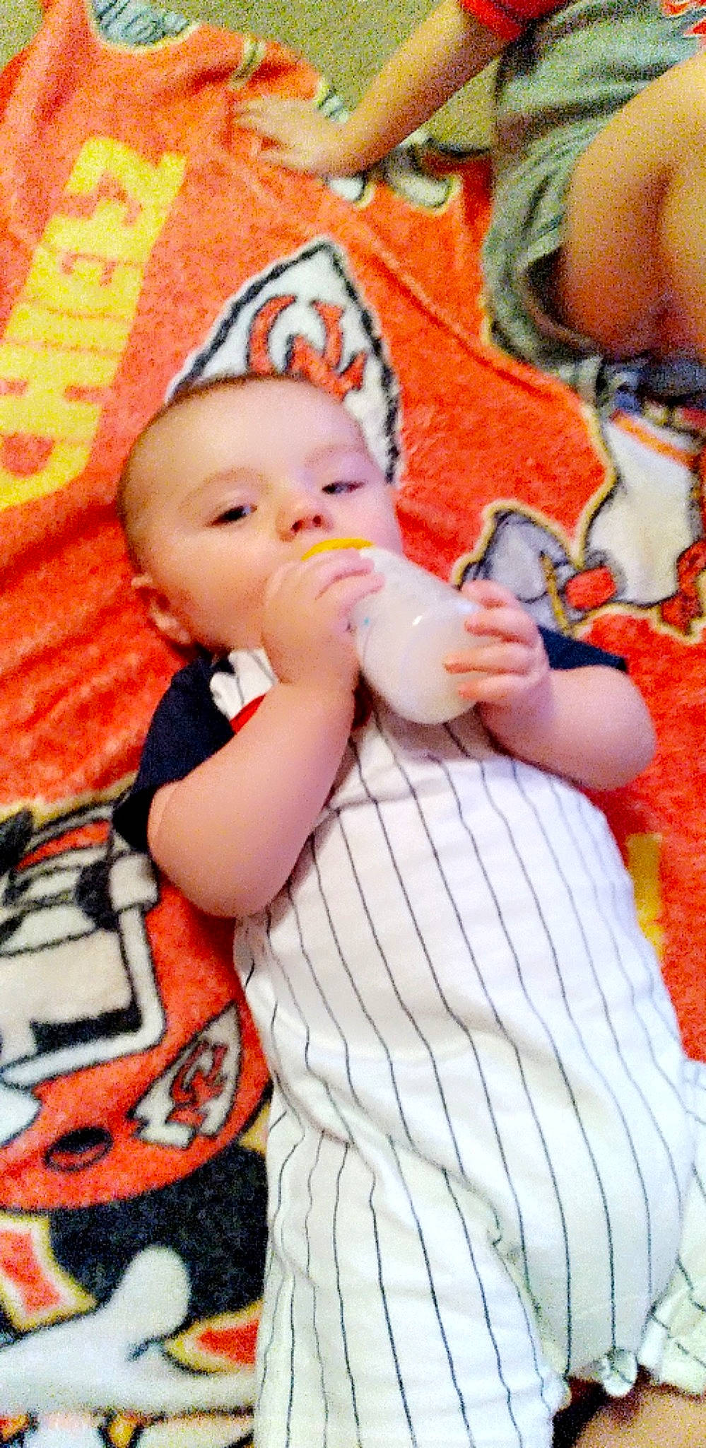 Kyle joined the competition — help win amazing prizes! baby, baby_products, baby_toddler_clothing, cheek, child, facial_expression, finger, fun, happy, lip, mouth, nose, orange, pattern, person, pink, skin, sleeve, textile, thumb