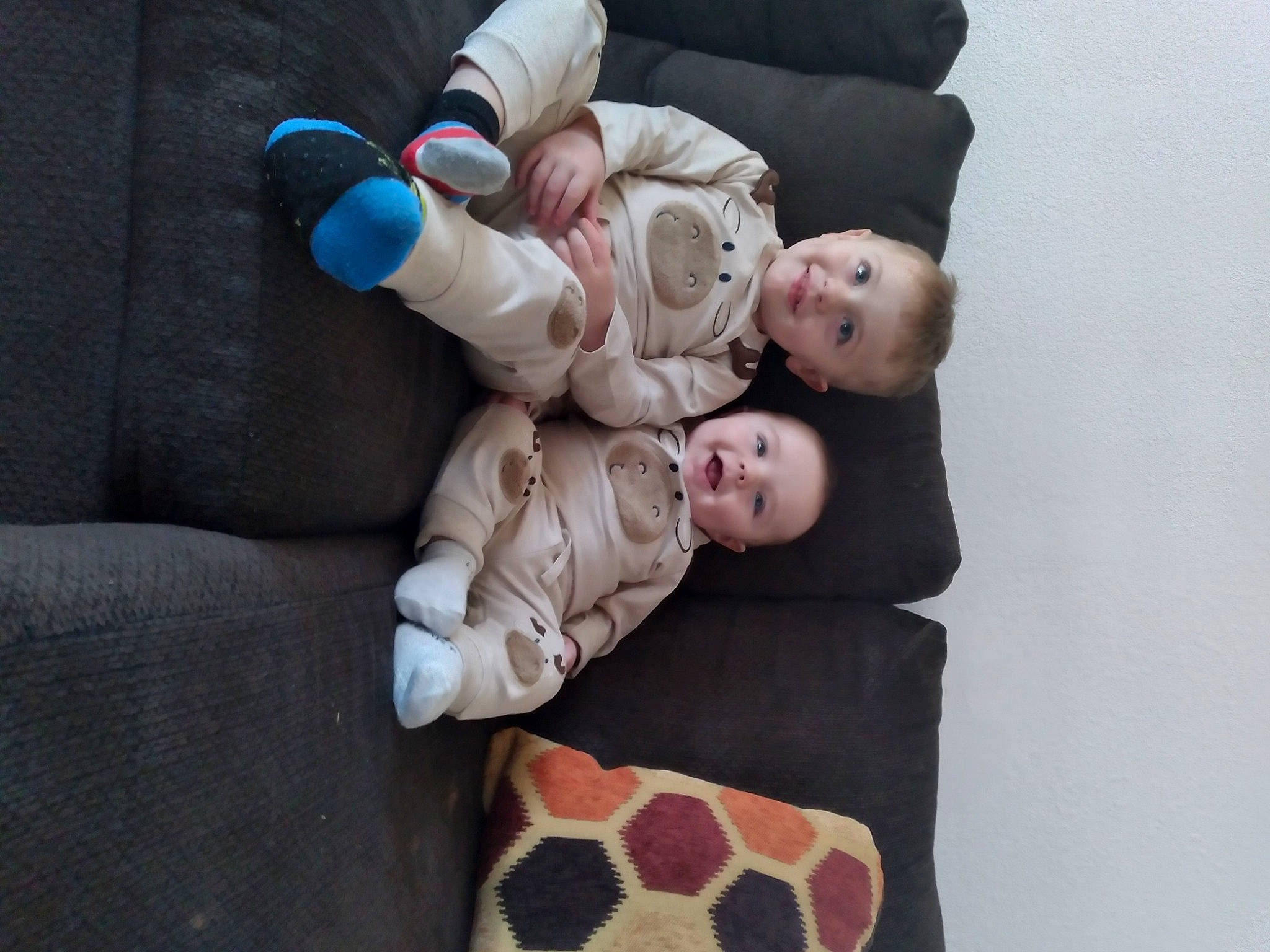 Colton is registered to the contest to win money with this photo: baby, baby_products, baby_toddler_clothing, child, comfort, couch, foot, fur, gesture, hand, happy, joy, linens, pattern, person, room, sitting, sleeve, smile, toddler