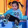 child, toddler, pigtails, blue_sweatshirt, bluey, slide, playground, sneakers, black_pants, smiling, outdoor, sunny, fun, active, young_child, playing, happy, casual_clothing, daylight, recreation