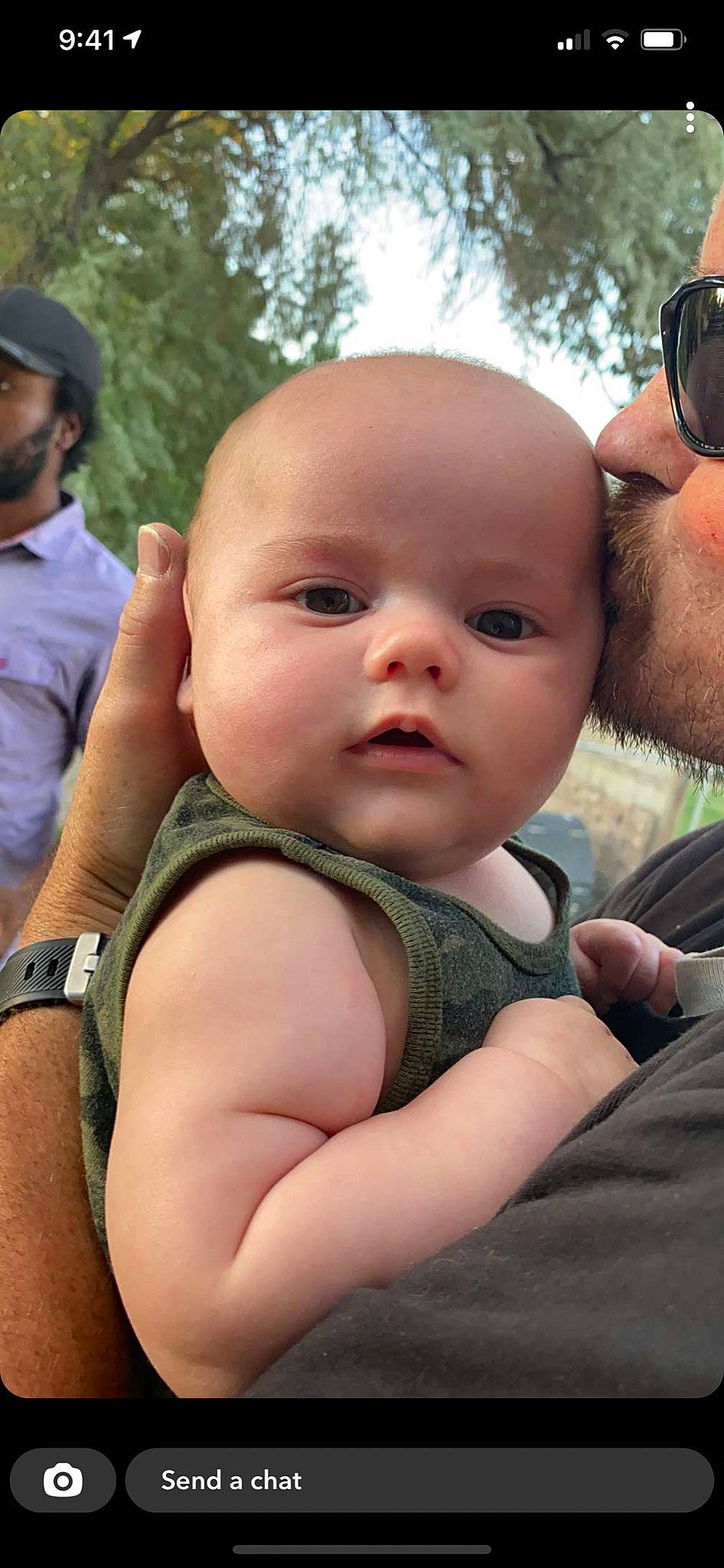 Ozzy is registered to the contest to win money with this photo: baby, baby_toddler_clothing, cheek, chin, cool, eyewear, facial_expression, gesture, grass, happy, interaction, iris, lip, mouth, nose, organ, person, skin, toddler, tree