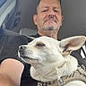 Aurore a rejoint le concours — aidez-le/la à gagner de superbes lots ! beard, car_interior, casual, closeup, companion, dog, glasses, harness, indoor, man, pet, portrait, relaxed, resting, seat, seatbelt, side_view, travel, white_dog, window