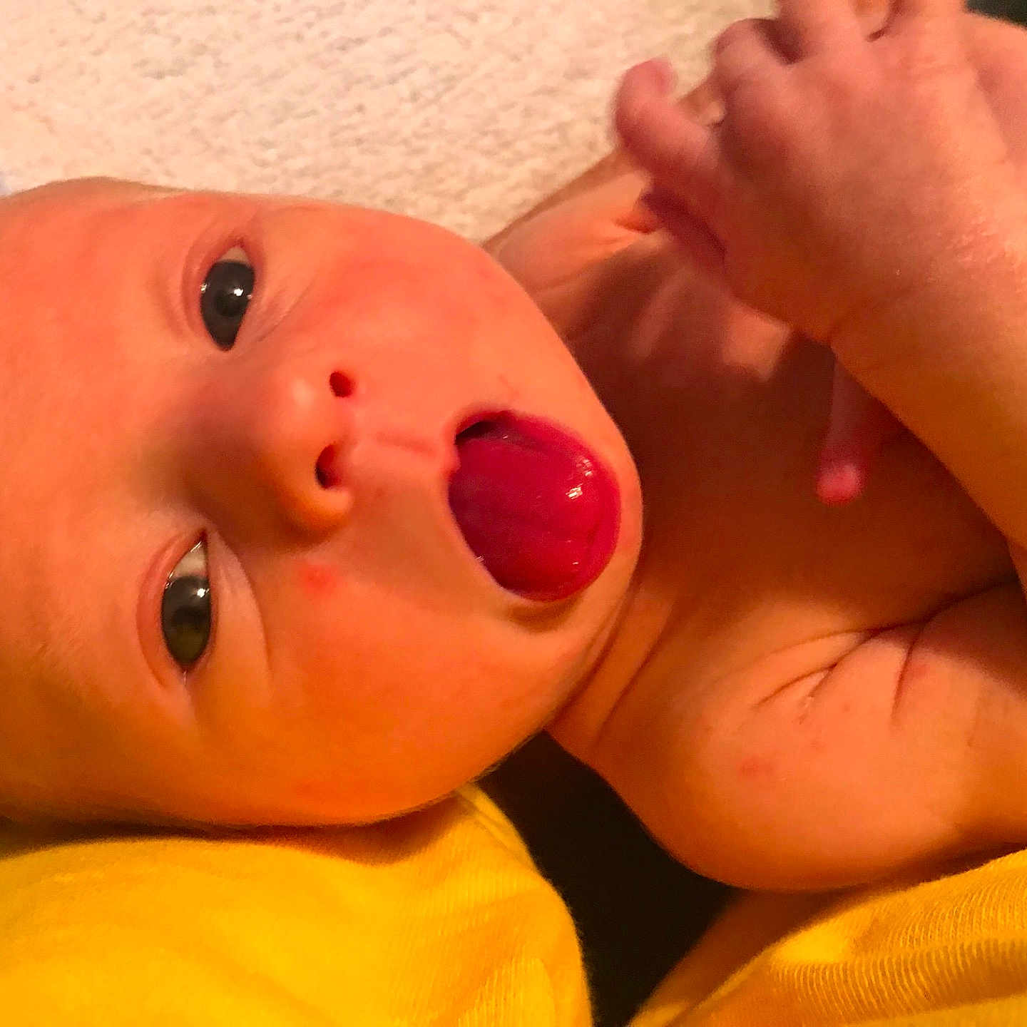 Tommy is registered to the contest to win money with this photo: cheek, child, close_up, ear, face, finger, hand, head, infant, lip, mouth, nail, neck, nose, thumb, toddler, tongue