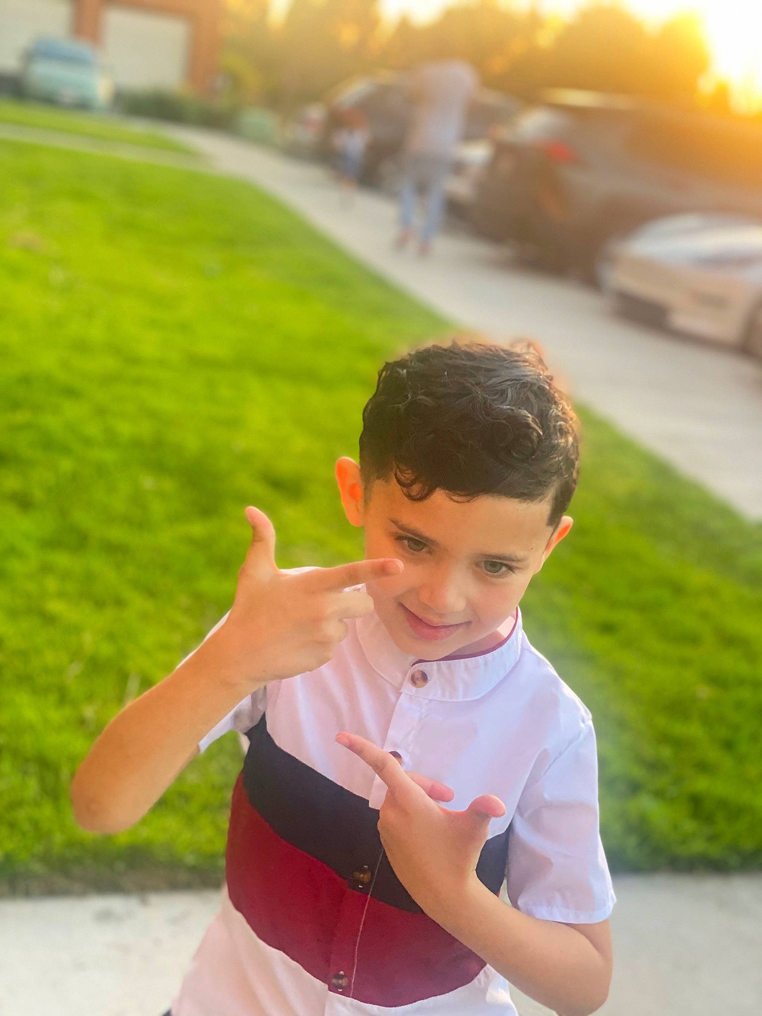 Antonio is registered to the contest to win money with this photo: asphalt, baby_toddler_clothing, dress, flash_photography, fun, gesture, grass, happy, human_body, joy, lawn, leisure, morning, person, plant, recreation, sleeve, smile, summer, sunlight